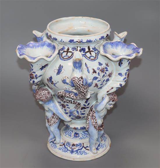 An early 19th century faience putto and cornucopia vase